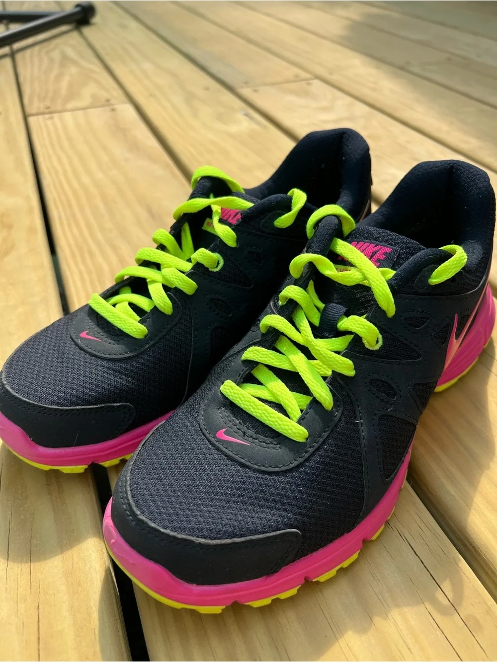 Nike Women’s navy Sneakers with Hot Pink & Neon Yellow Accents.Nike Revolution 2